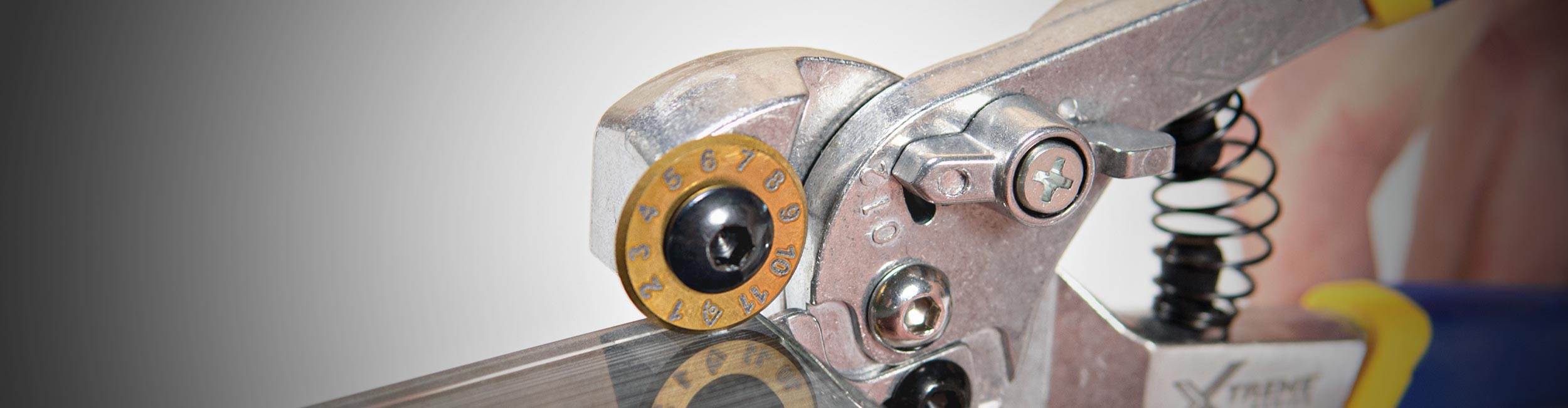 Close-up of an installer using a QEP Xtreme Pro Control Glass Tile Nipper to cut a glass tile