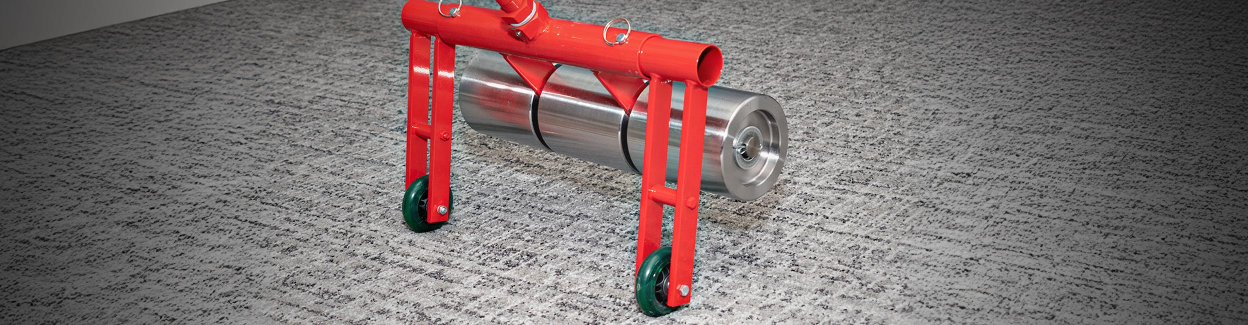 Close-up of an installer pressing sheet vinyl with a ROBERTS Heavy-duty Flooring Roller during installation