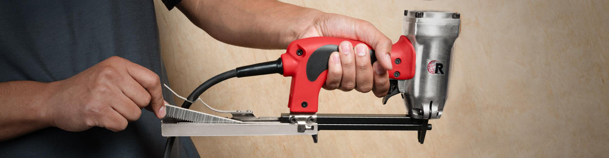 Close-up of a sleeve of crown staples being inserted into ROBERTS Electric Carpet Stapler