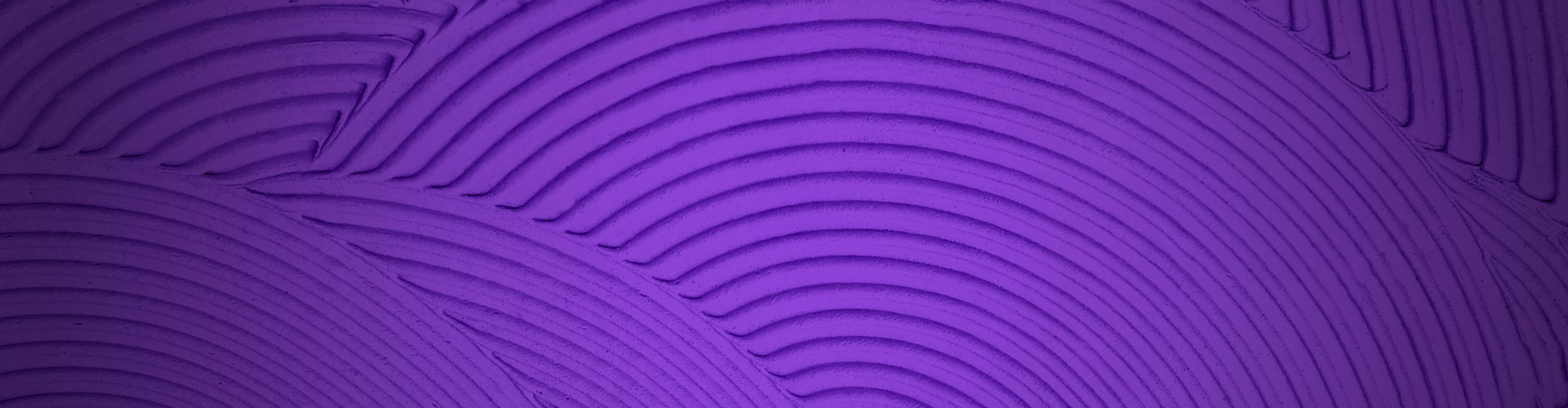 Close-up of textured trowel ridges with circular patterns on a purple background