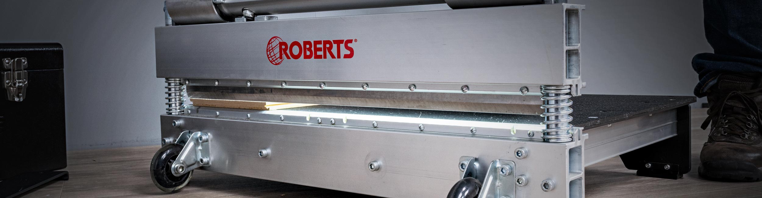 Close-up of the blade cutting a vinyl plank of the ROBERTS 25" PrecisionCuts Pro Multi-Floor Cutter