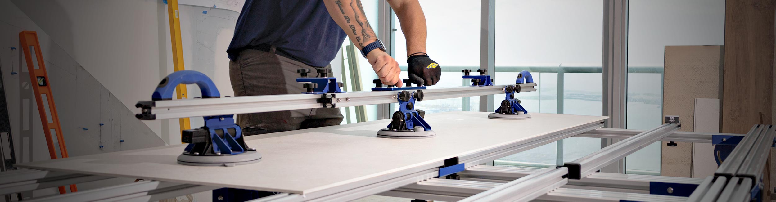 Installer adjusting QEP's GPTP Carrying System on a large tile panel