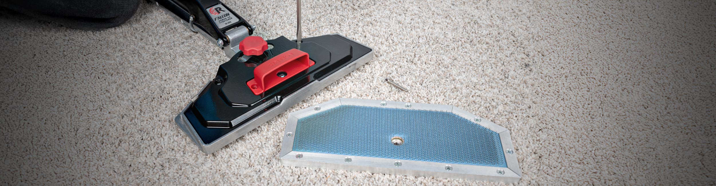 A professional installer using a ROBERTS Power-Lok Carpet Stretcher to stretch and secure carpet